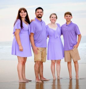 Cassandra on the beach with her family.