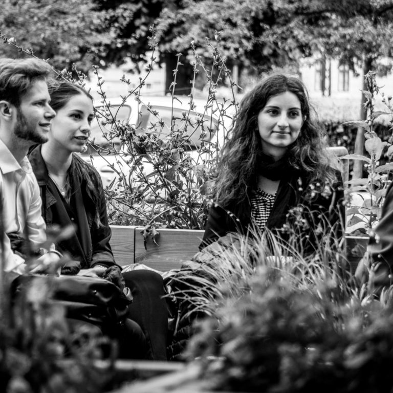 Readers sitting with their book in the reading garden.