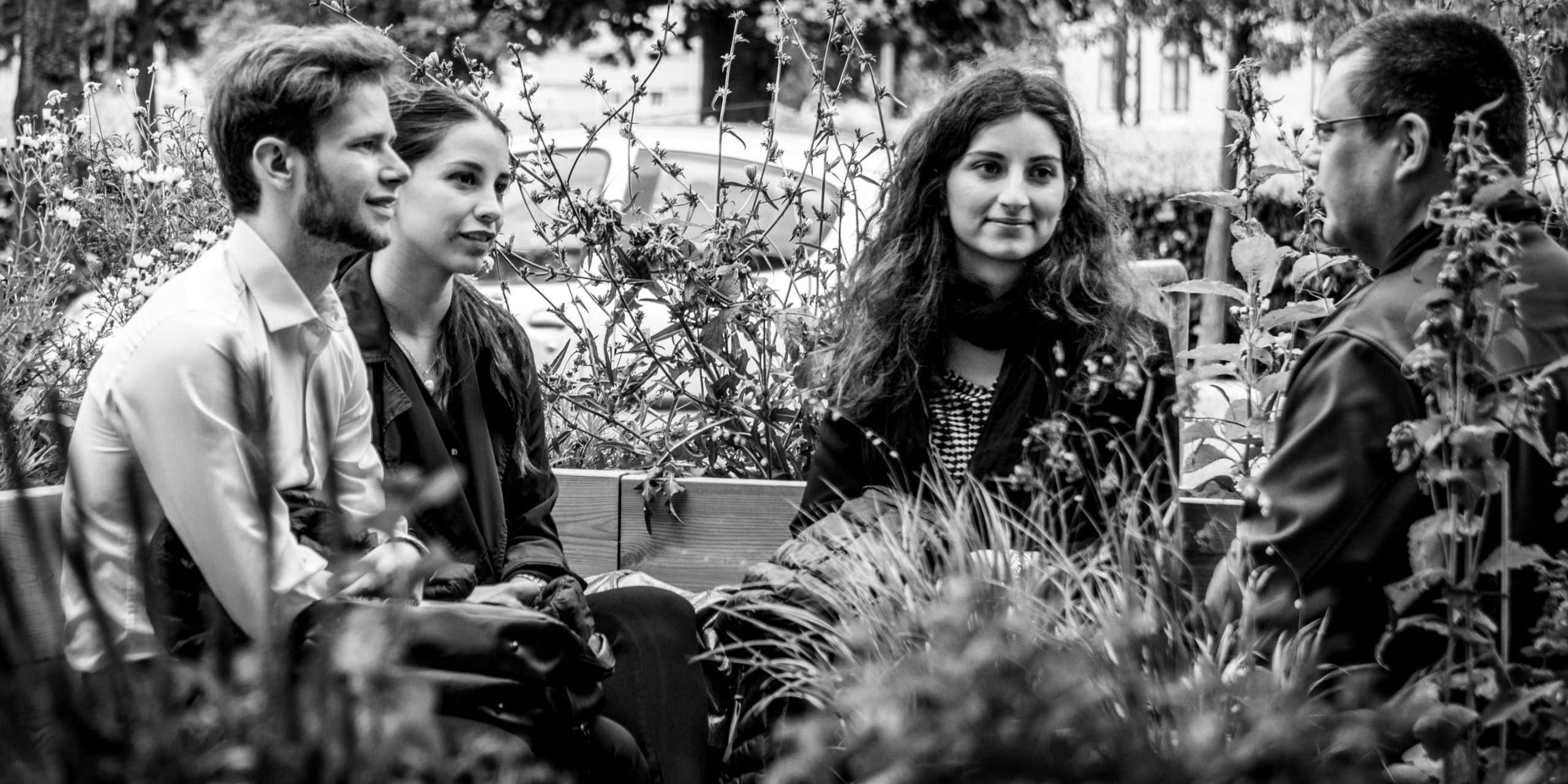 Readers sitting with their book in the reading garden.