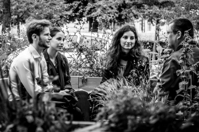 Readers sitting with their book in the reading garden.