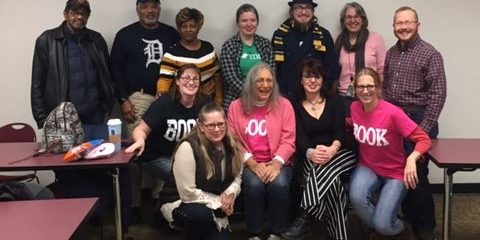 Standing behind her books in the back right wearing a pink sweater is Human Librarian Allison McFadden-Keesling from Oakland Community College.