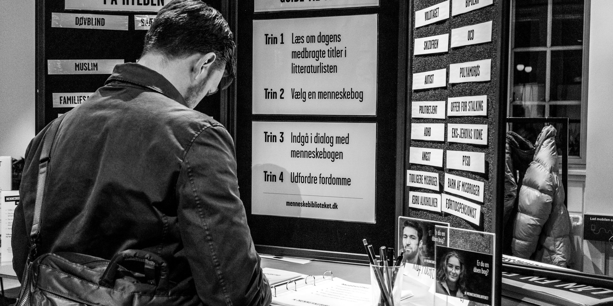 A reader in front of the Human Library desk